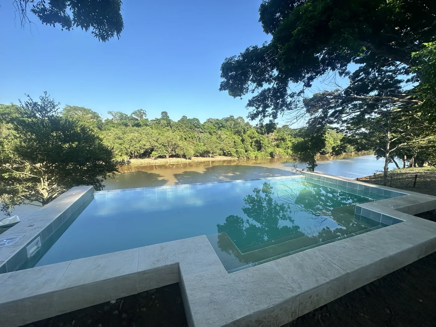 Infinity pool overlooking the lagoon at Chuchini Eco Lodge inside Chuchini Private Amazon Jungle Reserve near Trinidad, Bolivia
